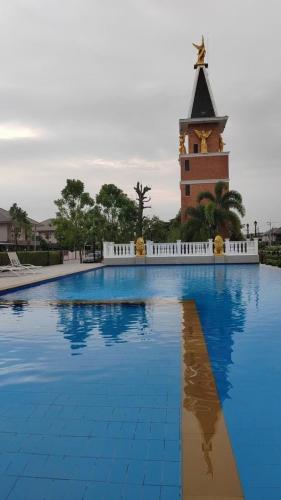 a large swimming pool with a clock tower in the background at Venice 3 bedroom, 3 bathroom, single family villa in Ban Nong Chaeng