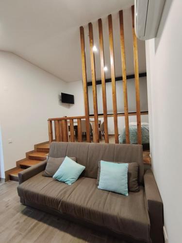 a living room with a couch with two blue pillows at Villa Lamegal in Pinhel