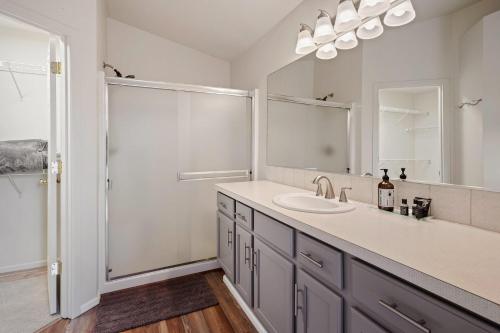 a bathroom with a sink and a mirror and a shower at Old Mill Magic in Bend