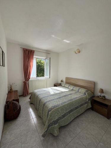 a bedroom with a bed and a window at Al Capitel in Grosotto