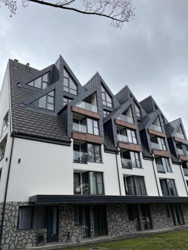 an apartment building with black roof at Divčibarski kutak in Divčibare