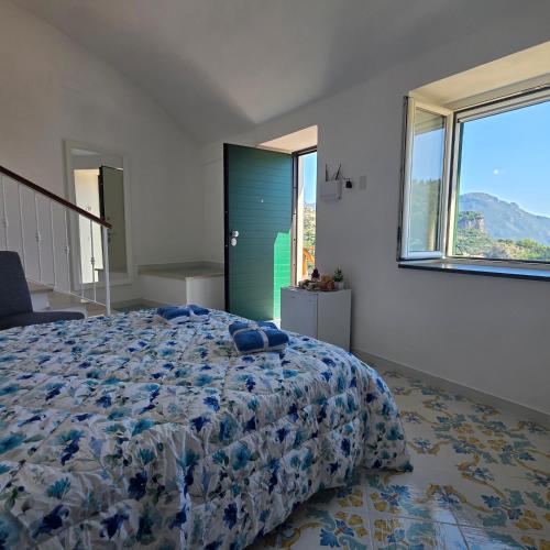 a bedroom with a bed and a green door at JANET HOUSE in Amalfi
