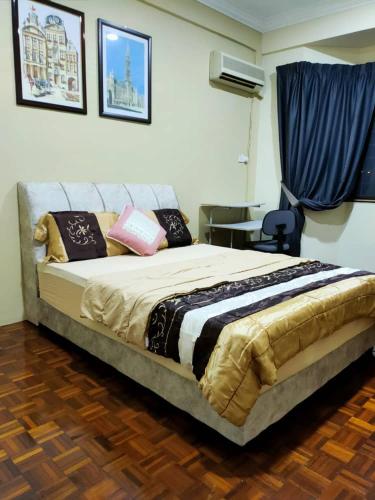 a bedroom with a large bed with pillows on it at HANNI HomeStay in Sibu