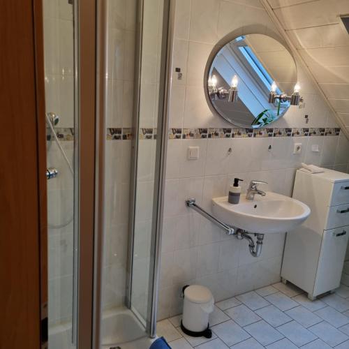 a bathroom with a shower and a sink at Gästezimmer Aschenbrenner in Bad Rodach