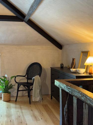 a chair and a table in a room with a ceiling at As Casinhas, Slow Living in Minho Quinta in Fontão