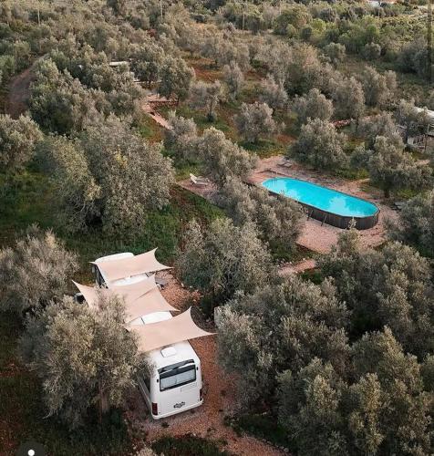 an aerial view of a rv parked next to a pool at Glamping Algarve Olive Tree Lodge in Nora