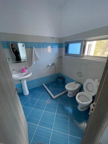 a bathroom with two toilets and a sink at Villa Hoxha Tepelen in Tepelenë
