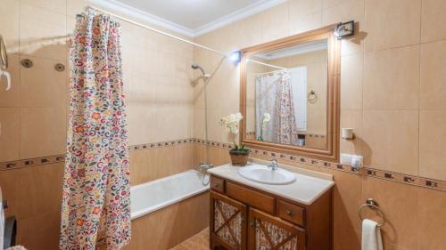 a bathroom with a sink and a shower curtain at Casa Abril by Ruralidays in Setenil