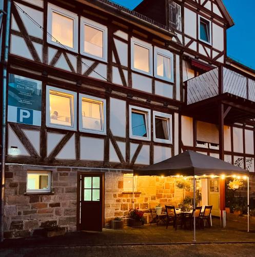 a building with an umbrella in front of it at Casa Bella in Guxhagen