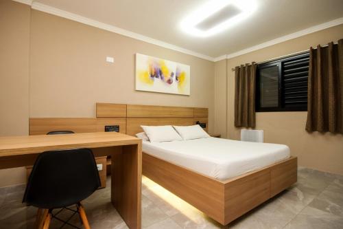 Una cama o camas en una habitación de For Lovers Jabaquara