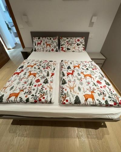 a bed with four pillows on top of it at Ciasa Enrico in Arabba