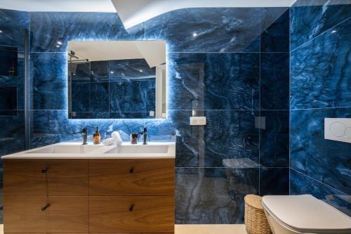 a blue bathroom with a sink and a toilet at Duplex Suite Old Town in Antibes