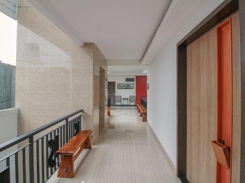 a hallway with a staircase with benches and a stair case at Sweet Karina Hotel Pasteur in Bandung