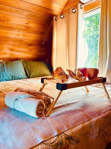 a bed in a room with a table on it at Recanto Monte Trigo in São Francisco do Sul