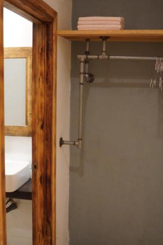 a closet with a glass door and a shelf at Hostel-John Cafe and Beer in Da Lat