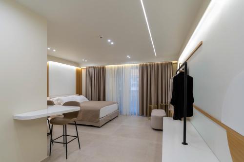 Un dormitorio con una cama, un escritorio y un televisor. en Thea Acropolis Suites & Apartments, en Atenas