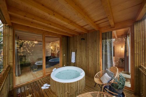 a jacuzzi tub on the deck of a house at HolaCamp Camino in O Pino 