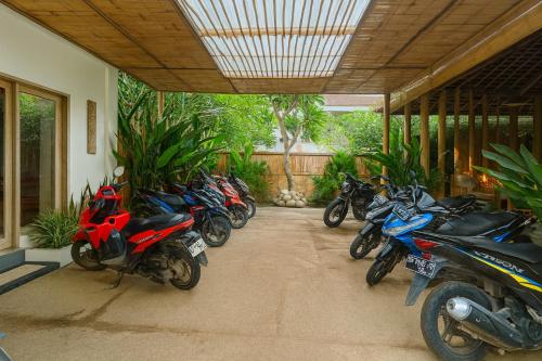 a row of motorcycles parked in a garage at Lavella Villas Kuta Lombok in Kuta Lombok