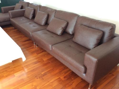 a brown leather couch in a living room at Seaside House Nirai in Miyako Island