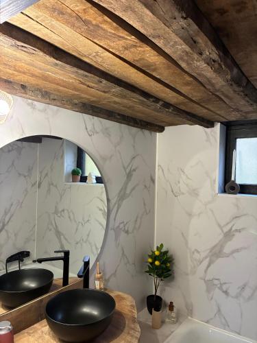 a bathroom with two sinks and a mirror at Cocoon Ny - DURBUY in Hotton