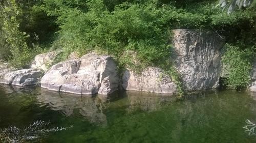 a body of water with a rock in the middle at Locanda di Campagna in Mulazzo