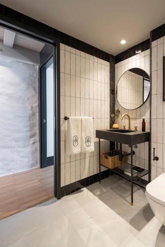 a bathroom with a sink and a toilet and a mirror at ART Boutique in A Coruña