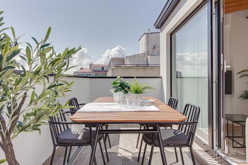 a wooden table and chairs on a balcony at Santa Lucía in A Coruña
