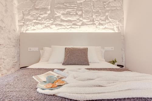 a white bed with a tray of food on it at Old Quarter Boutique in A Coruña