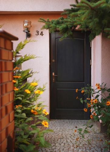 a black door on a building with flowers at Sportowa 34 in Bełchatów