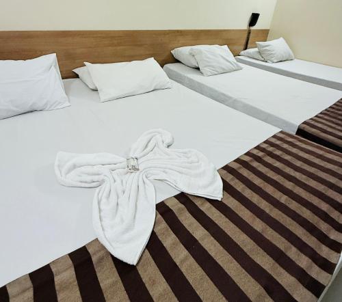 Ένα ή περισσότερα κρεβάτια σε δωμάτιο στο Hotel Express - Leva e busca no aeroporto grátis 24 horas