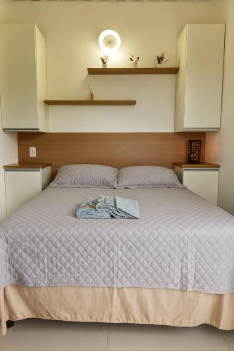 a bedroom with a bed with a robe on it at Janela da Canastra in Capitólio