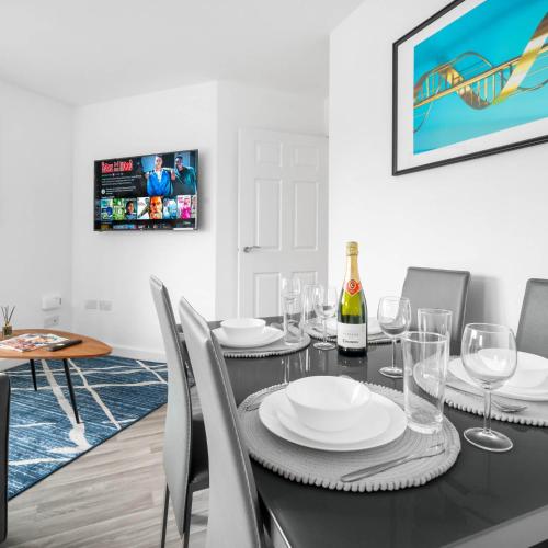 a dining room with a black table and chairs at 2 Bed Apartment - Sleeps 3 - Parking - Cradley Heath 54C in Netherton