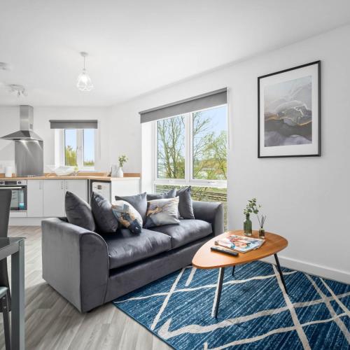 a living room with a couch and a table at 2 Bed Apartment - Sleeps 3 - Parking - Cradley Heath 54C in Netherton