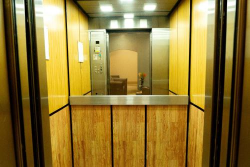 un couloir avec des murs en bois et un miroir dans l'établissement Hotel Benidorm Panama, à Panama City