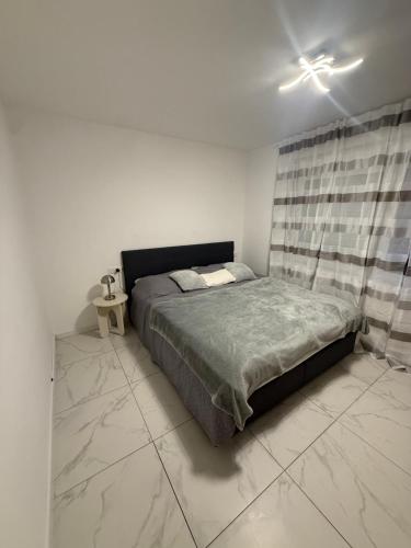 a bedroom with a bed in a white room at Apartment-Alex in Vienna