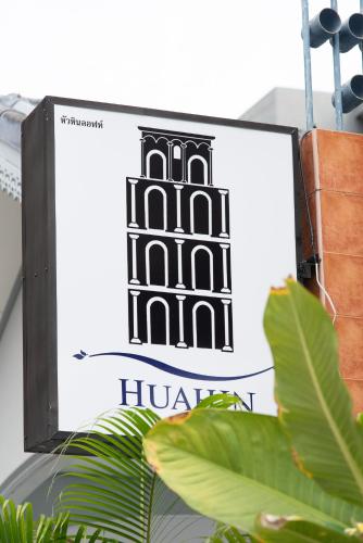 a sign for a huawei store with a plant at Hua Hin Loft in Hua Hin