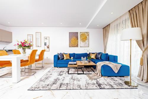 a living room with a blue couch and a table at Family Aparthotel in Casablanca