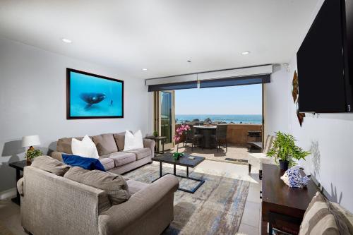 a living room with two couches and a large window at 700-104 Water Front Condo w AC in Oceanside