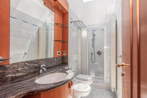 a bathroom with a sink and a toilet and a shower at Residence Riva degli Etruschi in San Vincenzo