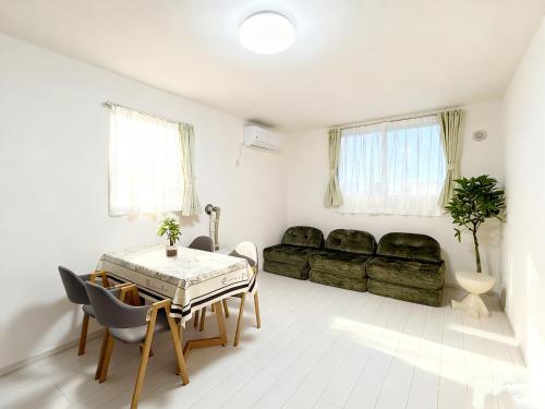 a living room with a table and a couch at Niseko Yotei Vista in Kutchan