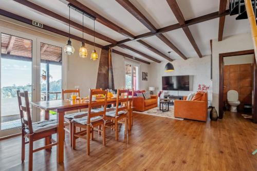 a dining room with a table and chairs at São Jorge Cottage - By WeHost in Santana