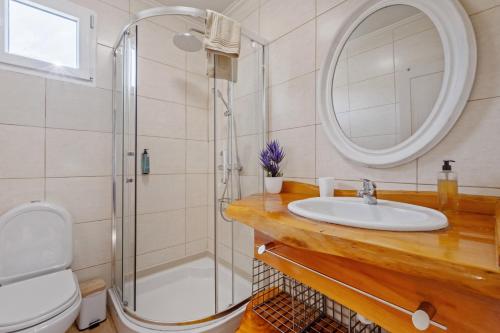 a bathroom with a sink and a shower at São Jorge Cottage - By WeHost in Santana