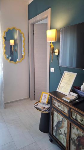 a room with a dresser and a mirror on the wall at Novecento in Bertinoro