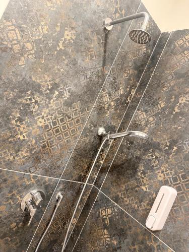 a shower in a bathroom with a glass wall at Ughetti Apartment in Palermo