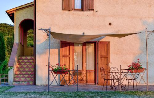 a patio with a table and chairs in front of a building at Pet Friendly Home In Pescina in Tepolini