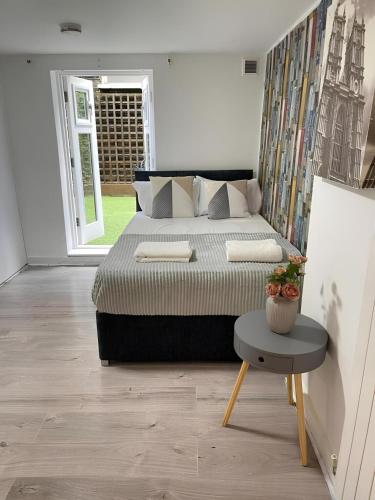a bedroom with a large bed and a table at Portobello Road Artistic Studios in London