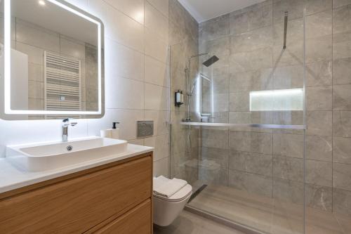 a bathroom with a toilet and a sink and a shower at K33- Quality Apartments, Best Location, by BQA in Budapest