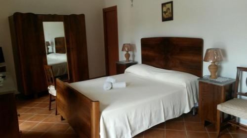a bedroom with a bed and a mirror at da Ciccio e Concy in Tursi