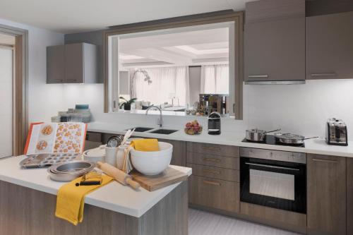 a kitchen with a counter with a large mirror at Shangri-La Residences The Fort, Manila in Manila