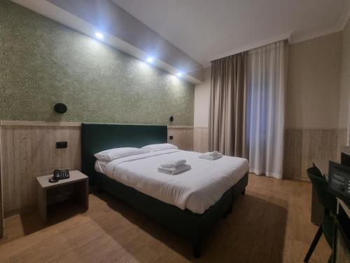 a hotel room with a large bed and a television at Hotel Pyramid in Rome